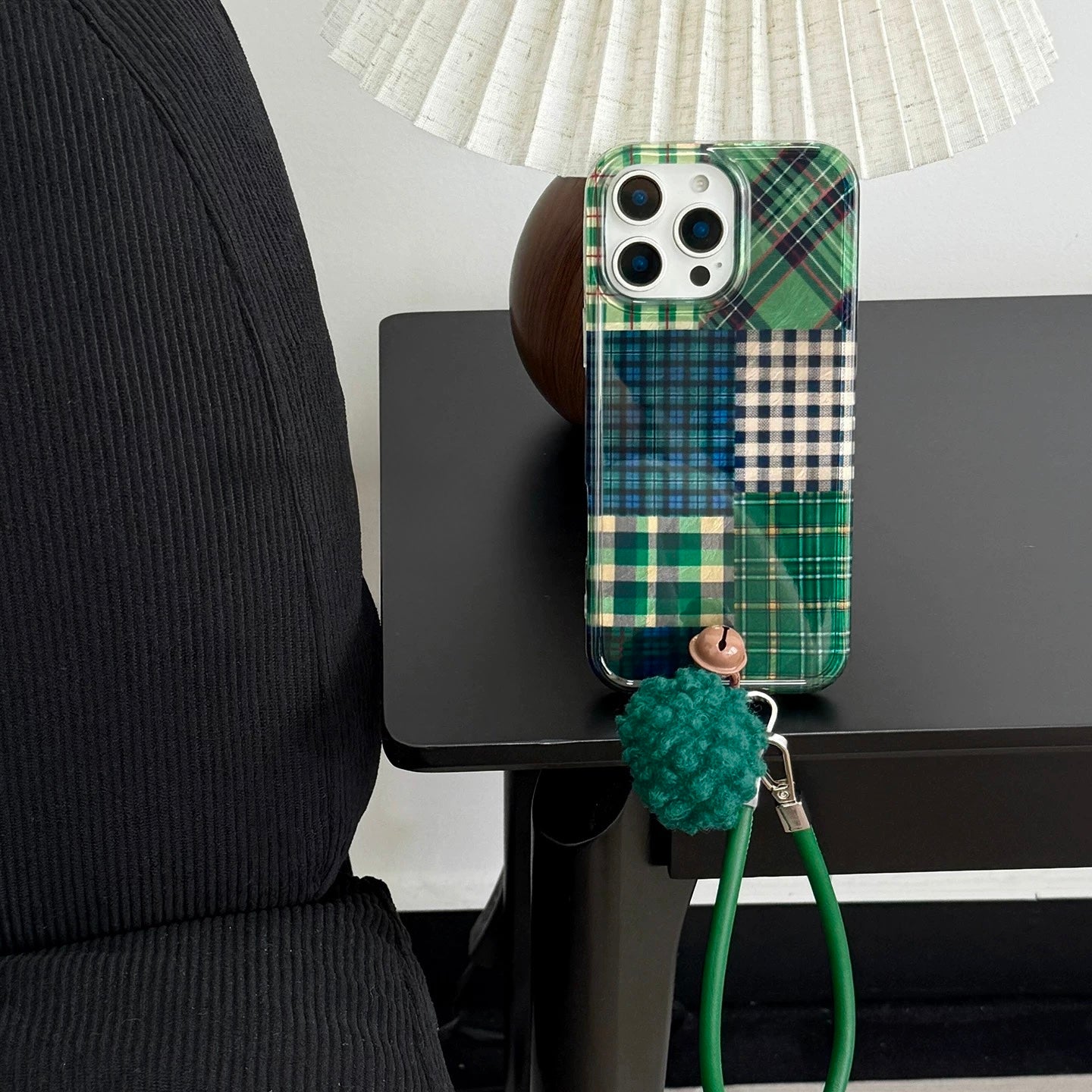 Forest green check iPhone case on leather chair