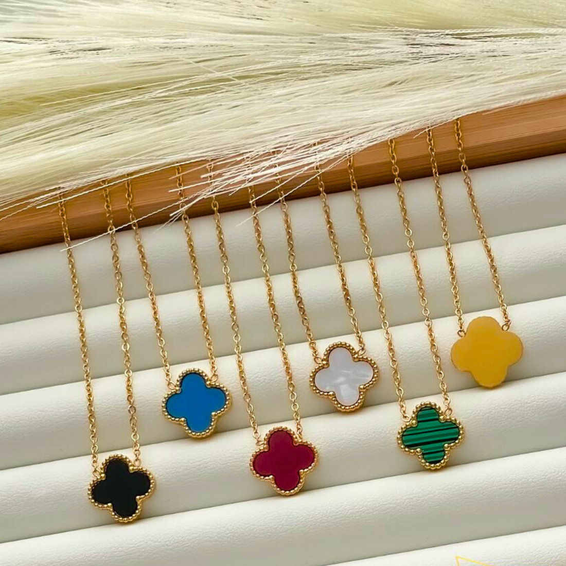 Gold four-leaf clover necklace with dainty charm