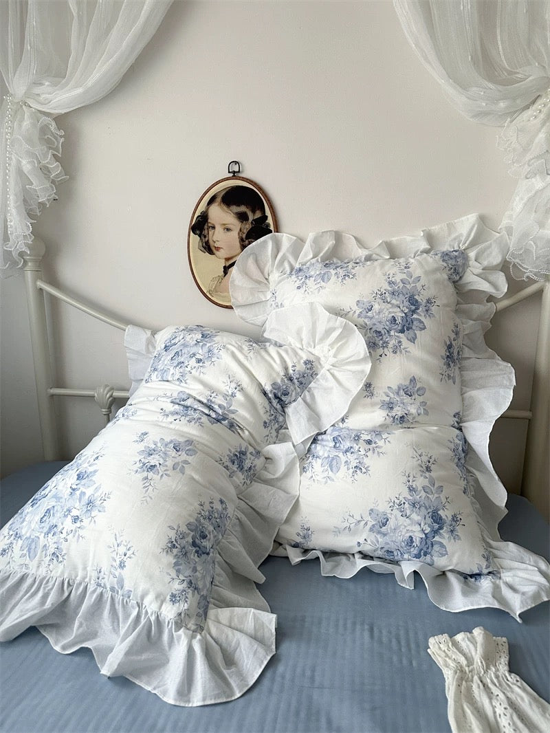 Cottagecore bedroom styled with blue floral ruffle bedding and pastel accents.