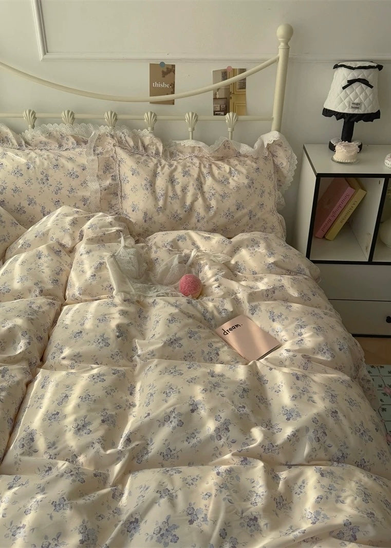 Bed with floral bedding and pillows in a bedroom setting.