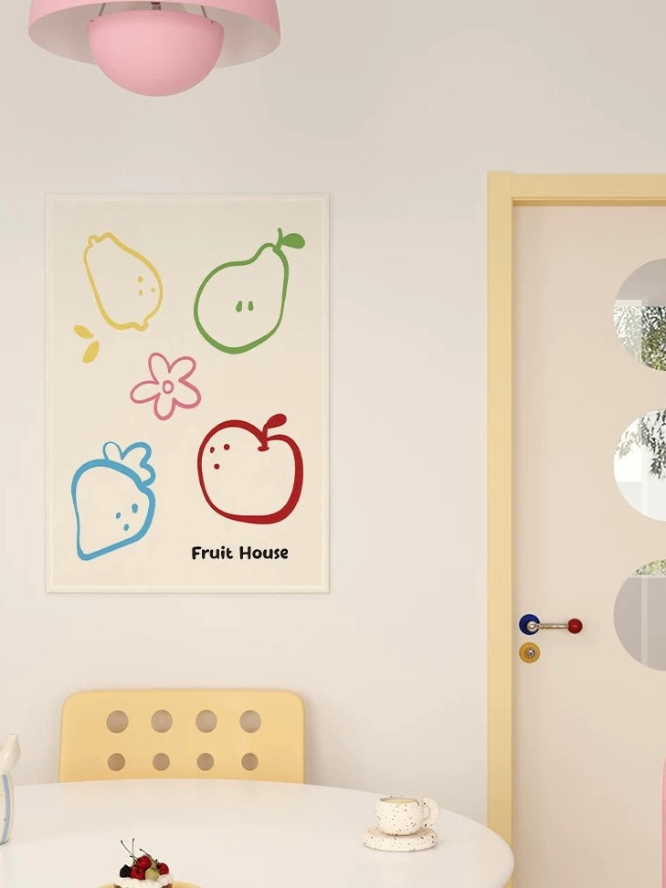 A cream fruit tapestry shows colorful fruit outlines and a pink flower above a small dining table.