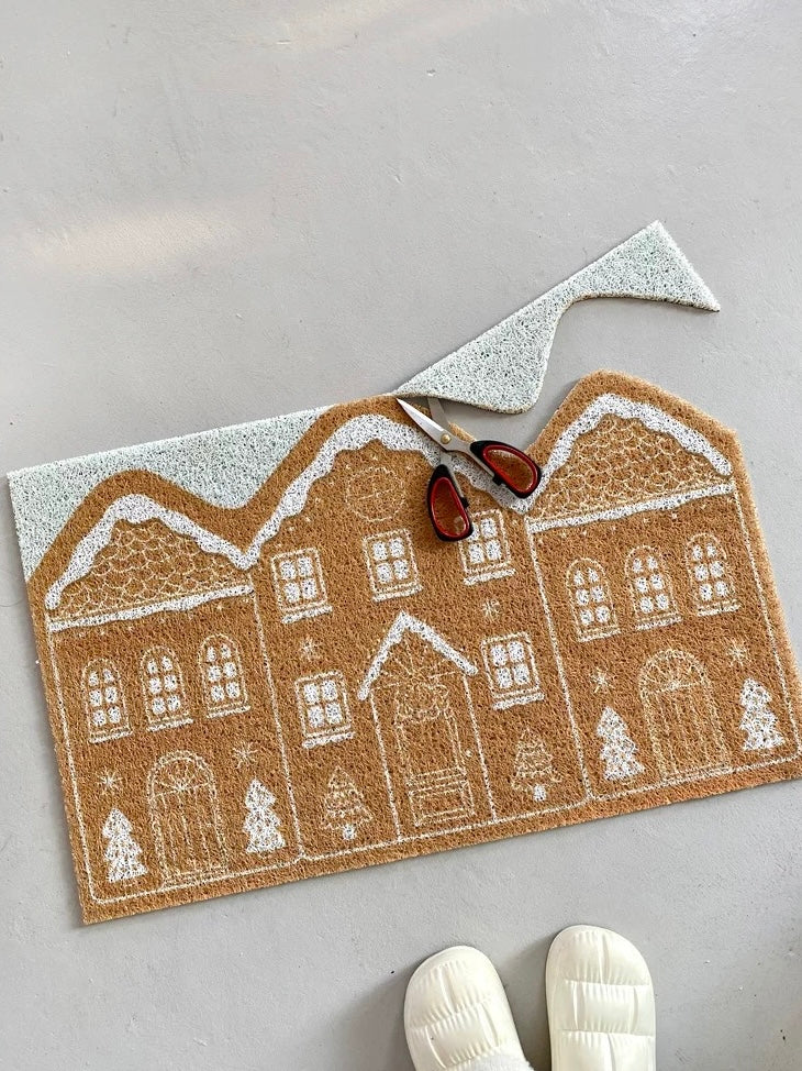 Cinnamon gingerbread house entryway rug styled on gray flooring