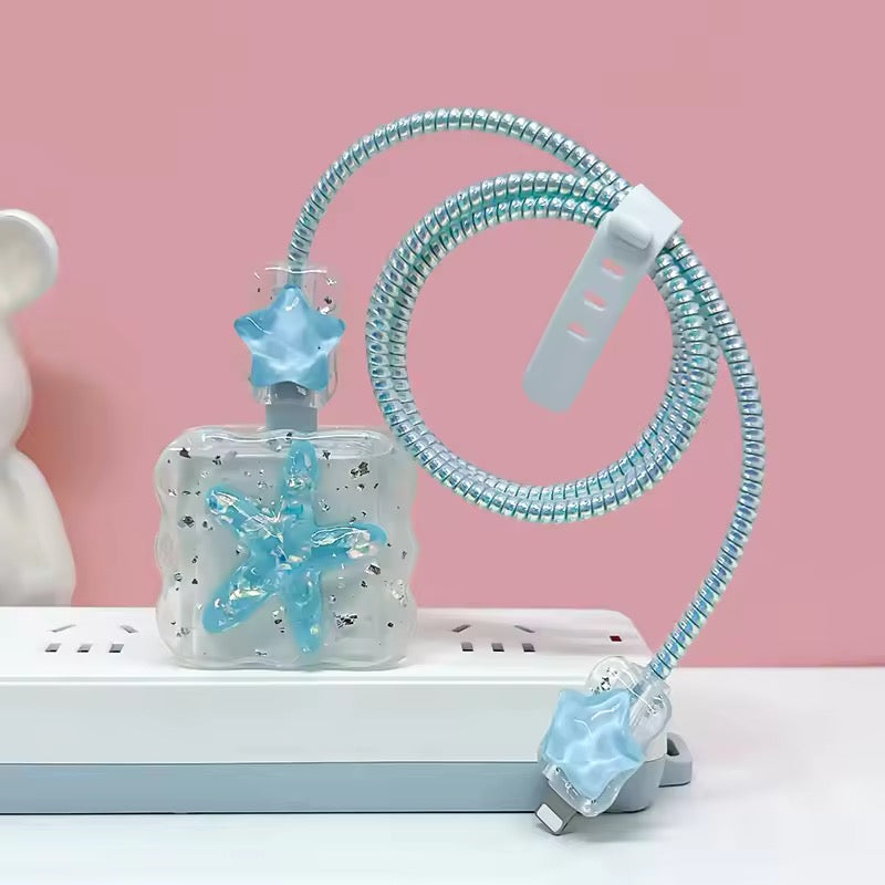 Clear device with blue starfish designs and a flexible hose on a pink background