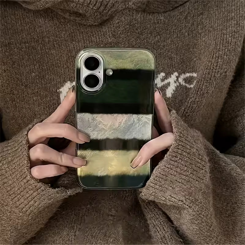 Person holding a phone with a marbled case, wearing a brown sweater.