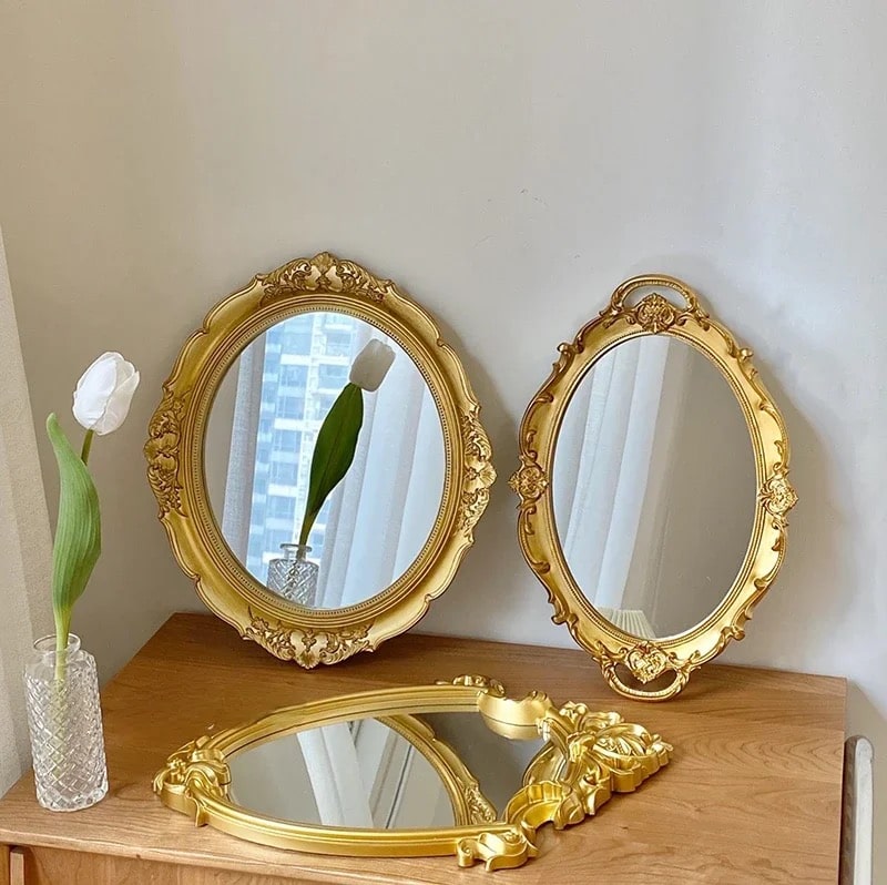 Oval gold dresser tray with intricate metal details