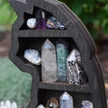 Gothic black cat shelf displaying crystals and spiritual items