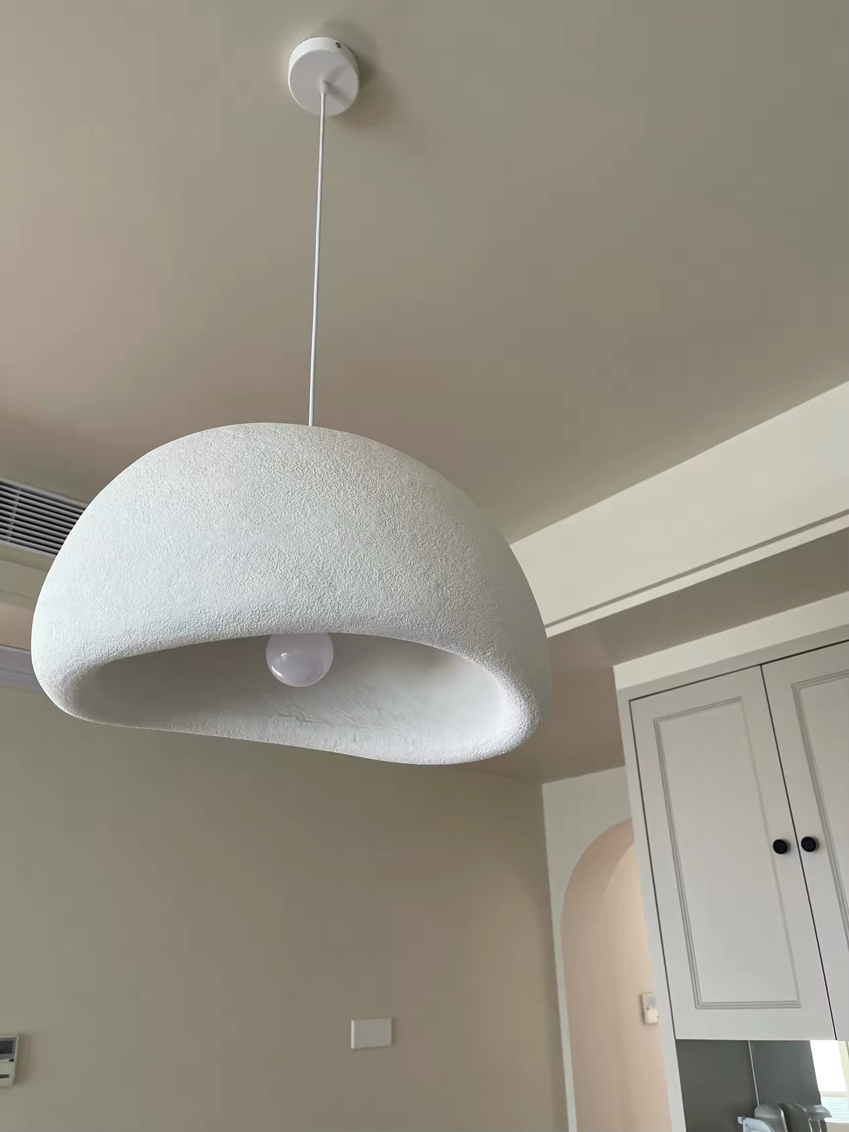 Nordic minimalist LED light in white, hanging in bright interior