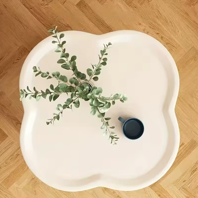 Pastel green table with storage shelf under, decorated with tulips and accessories