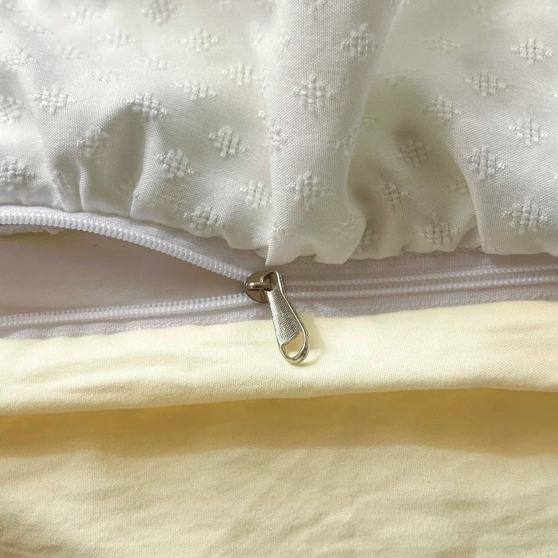 Close-up of a white textured fabric with a zipper on a light background