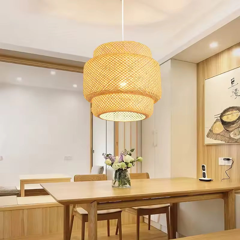 Handwoven bamboo pendant light casting warm glow in modern Japandi bedroom.