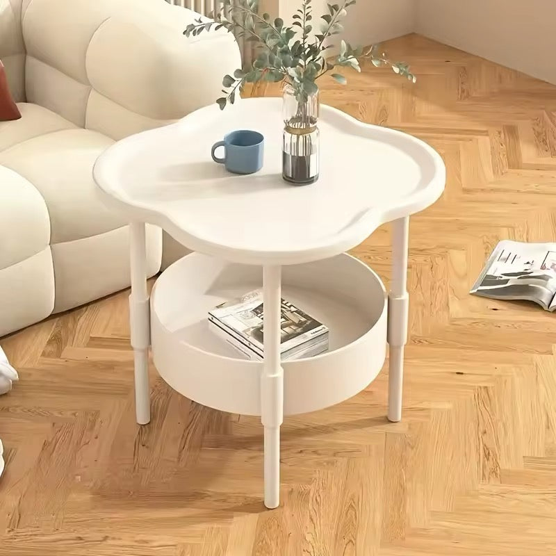Cream coffee table with soft edges used as aesthetic nightstand near couch