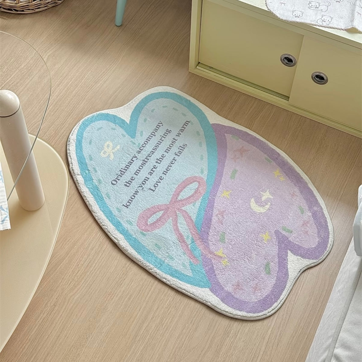 Pastel heart bath mat beside a white sofa and pale yellow cabinet on wood flooring