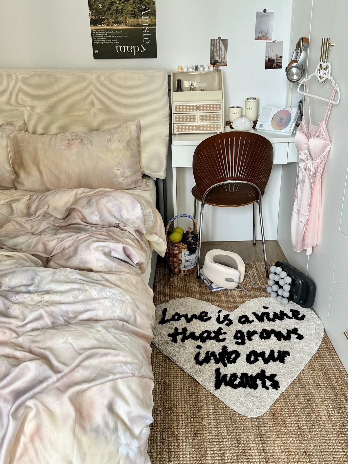 Cream and black heart shaped rug beside a bed and brown chair, with love lettering across the textured surface.