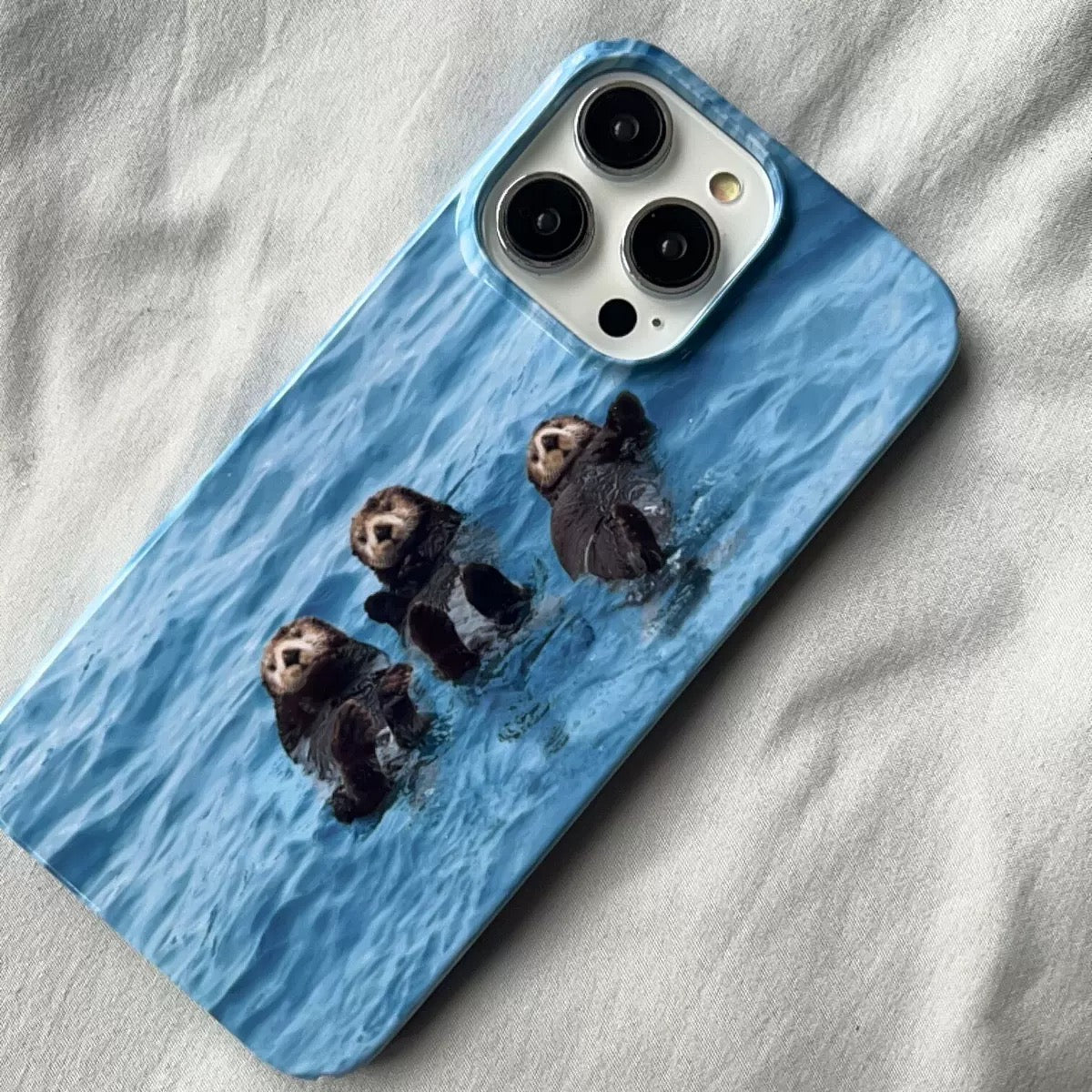 Wildlife-inspired otter phone case in blue for iPhone