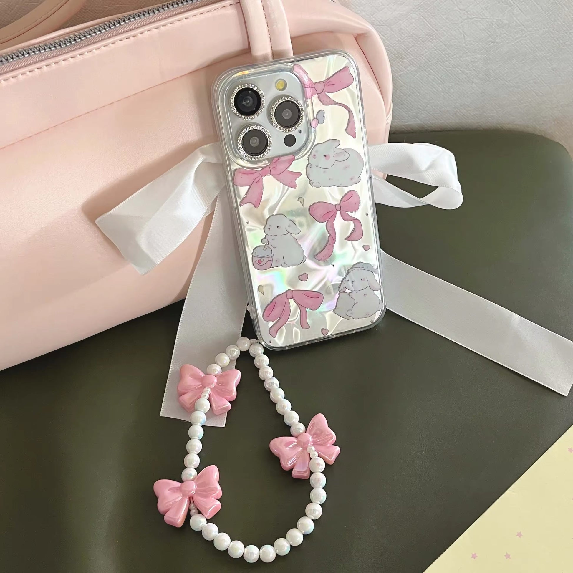 Pink coquette iPhone case with bracelet pendant