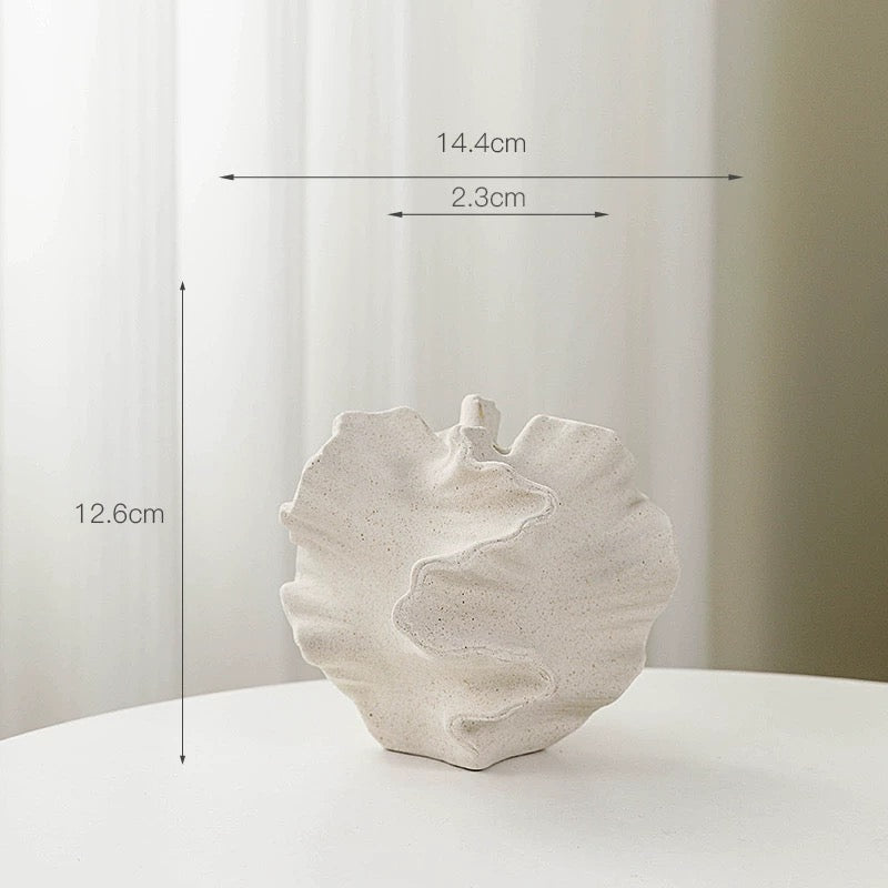 White ceramic shell-shaped vase with measurements on a white background
