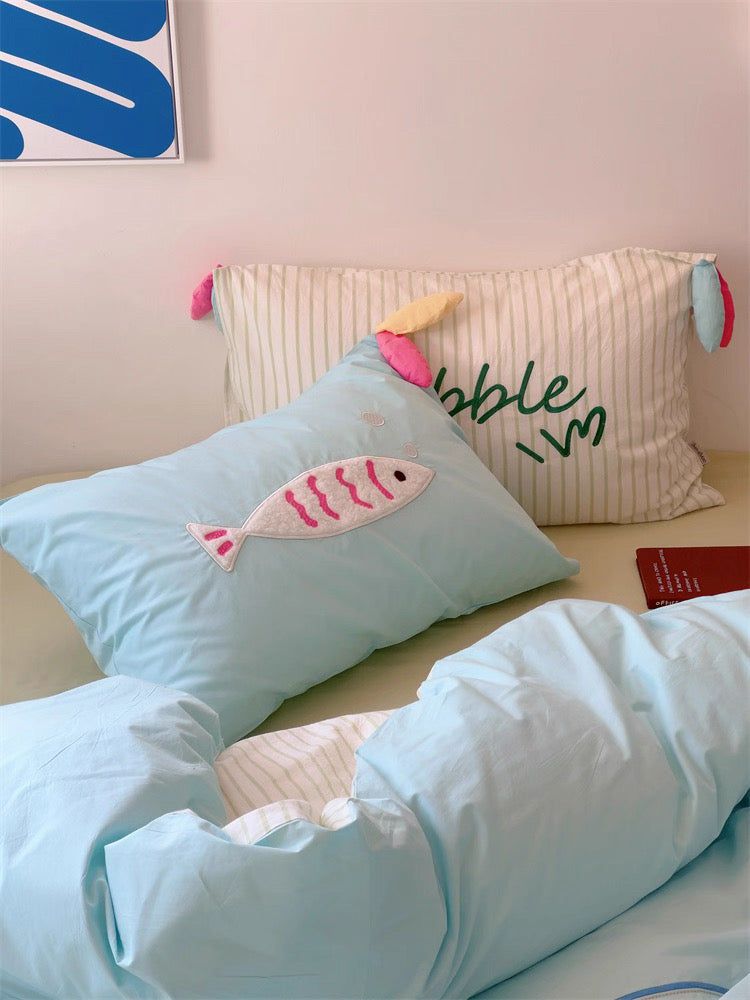 Embroidered duvet cover and pillowcase set on a neatly made dorm bed with kawaii touches.