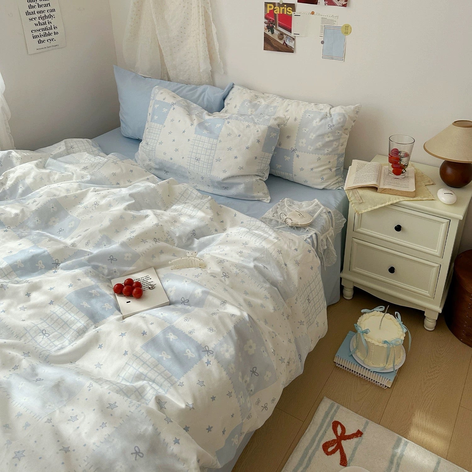 Soft girl bedroom styled with a pastel blue patchwork duvet cover set and plush toys.