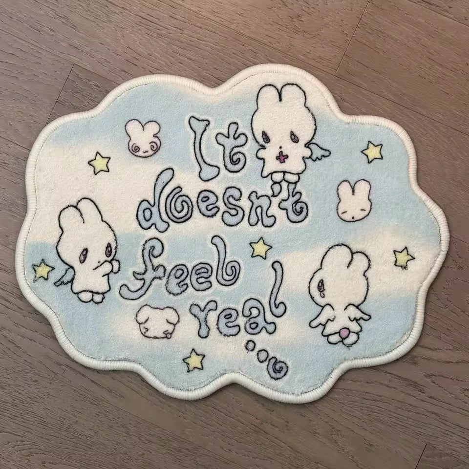 Embroidered patch with cartoon characters and text 'It doesn't feel real' on a wooden surface
