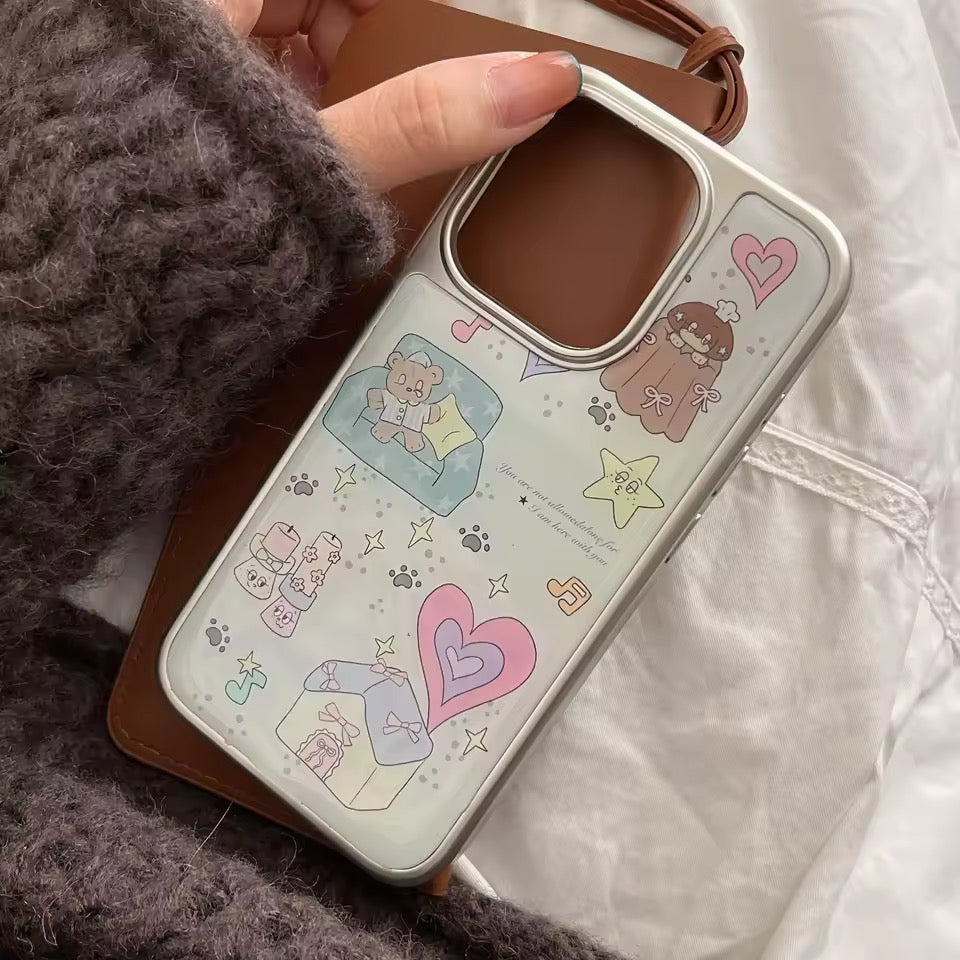 Phone case with cartoon designs held by a person wearing a textured sleeve.
