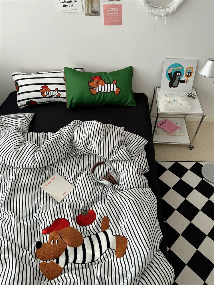 Children's bedroom with black and white striped bedding featuring cartoon characters, a green pillow, and a checkered floor.