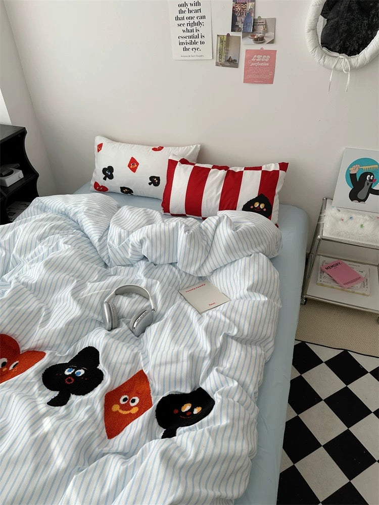 Bed with cartoon-themed bedding in a room with checkered floor and wall decorations.