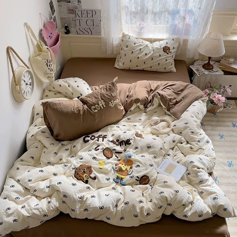 Close‑up of the kawaii embroidered coffee characters and tiny bow motifs on the duvet cover, perfect for coffee lovers.