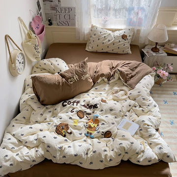 Close‑up of the kawaii embroidered coffee characters and tiny bow motifs on the duvet cover, perfect for coffee lovers.