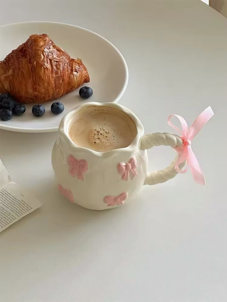Pastel kitchen with pink ceramic cup in view