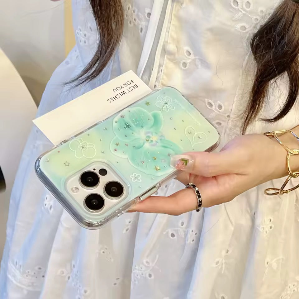 Person holding a phone case with a gradient design and bear illustration.