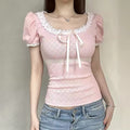 Light pink kawaii crop top with puff sleeves and bow detail.