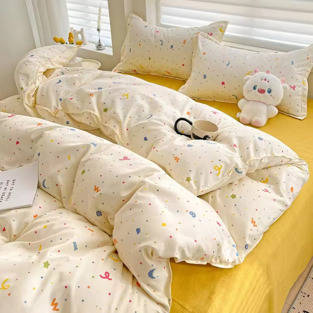 Overhead view of kawaii yellow bedding set with pastel confetti symbols on a sunlit bed