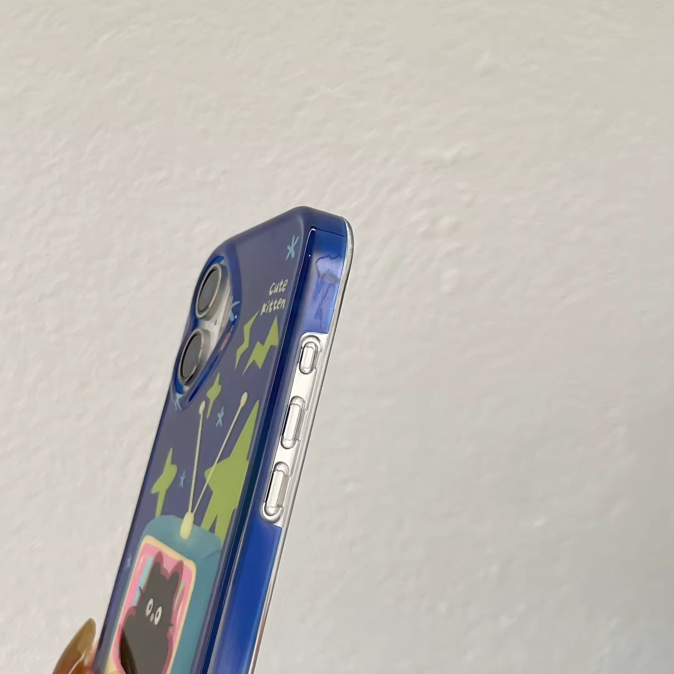 Blue and pink iPhone case with a bold cartoon cat and TV screen graphics