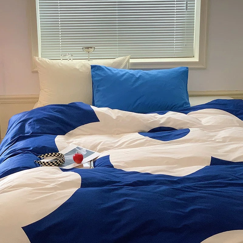 Clean, modern bedroom with statement floral bedding in deep blue