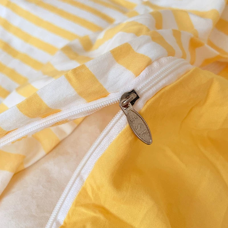 Close-up of a yellow and white striped fabric with a zipper