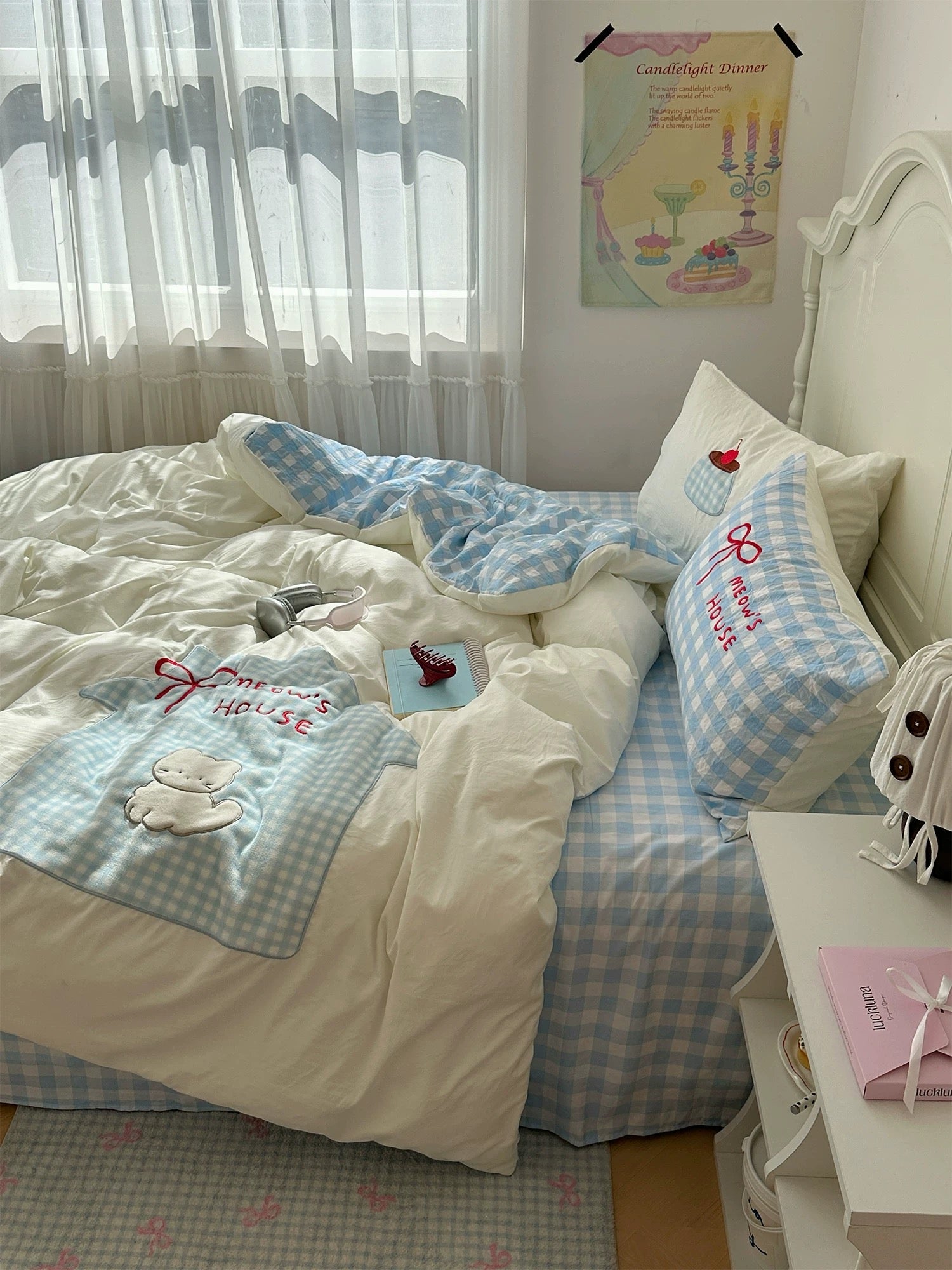 Pastel blue bedding set with cat applique embroidery and checkered design.