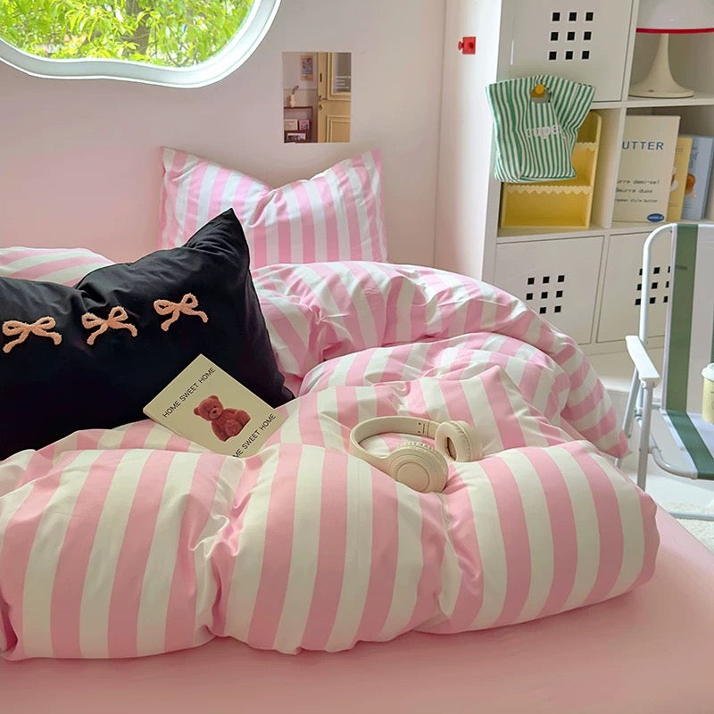 Coquette aesthetic bedroom featuring the pink striped bedding set with matching decor