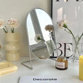 Rotating stainless steel mirror for vanity