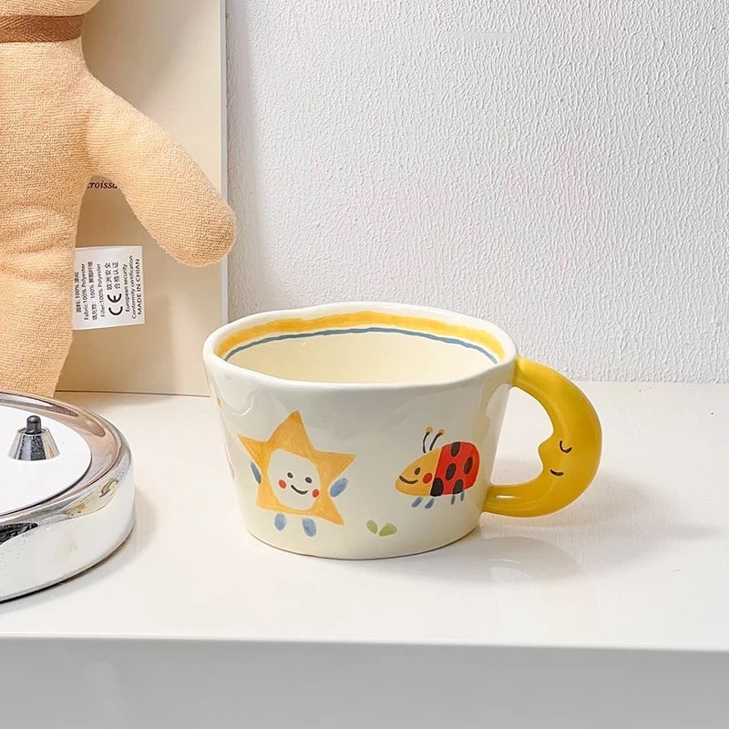 Hand-painted yellow ceramic mug with ladybug and dog designs. Artistic Korean style coffee cup for gifting.