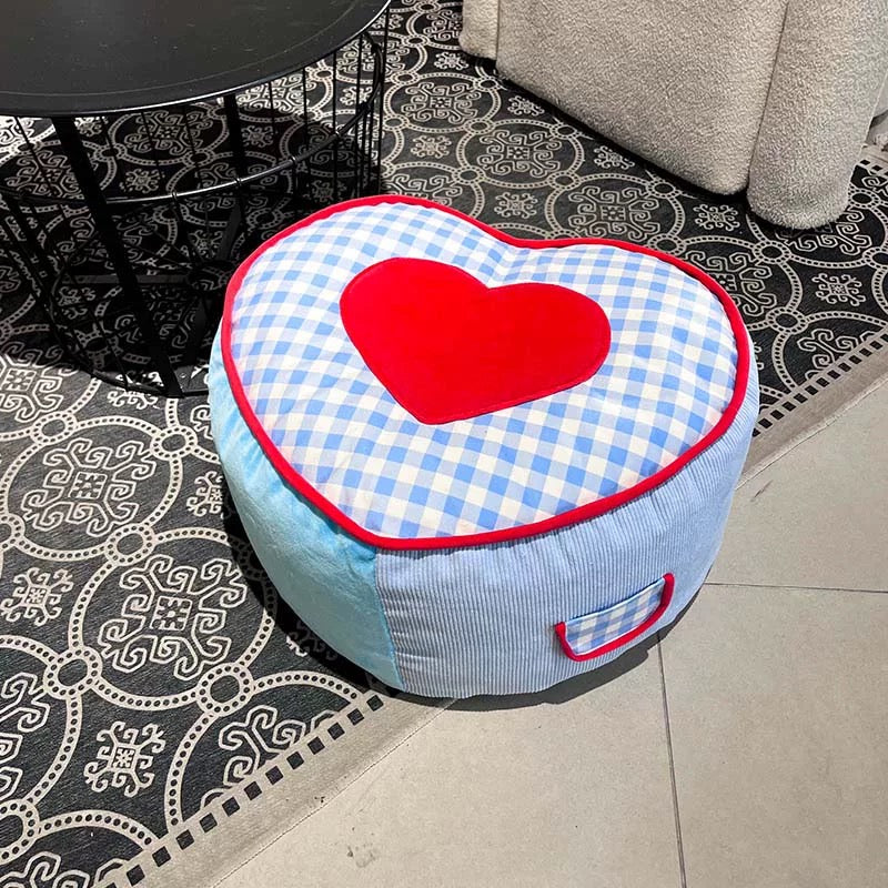 Gingham plaid pouf with red heart design for cozy Canadian bedrooms.