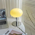 Contemporary lollipop table lamp illuminating a bedroom