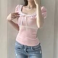 Y2K-style pink coquette top with lace trim and square neckline