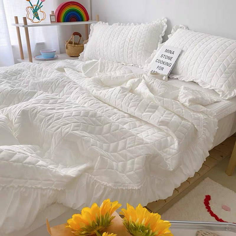 Ruffle bedding set with lightweight quilted blanket and matching pillowcases
