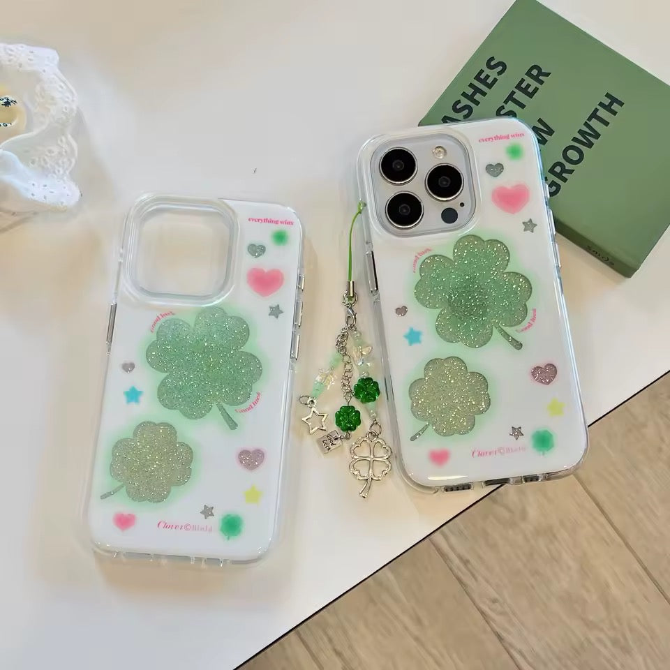 Phone case with four-leaf clover design on a light surface