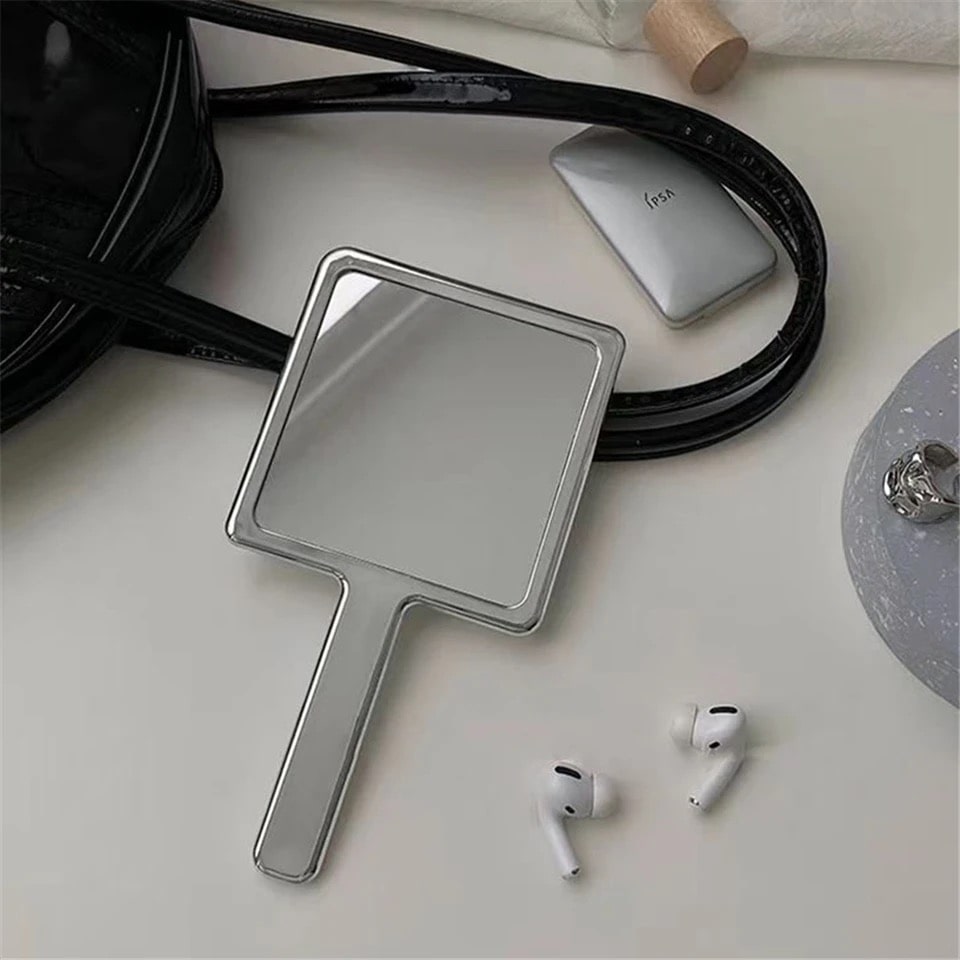 Melted metallic handheld mirror with liquid wave design