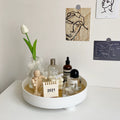 Minimalist wooden storage tray on table with decorative items.