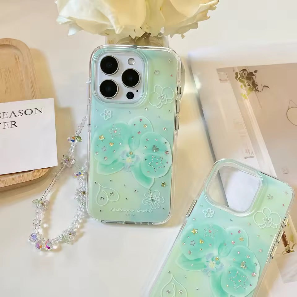 Green phone case with floral design and chain on a light background