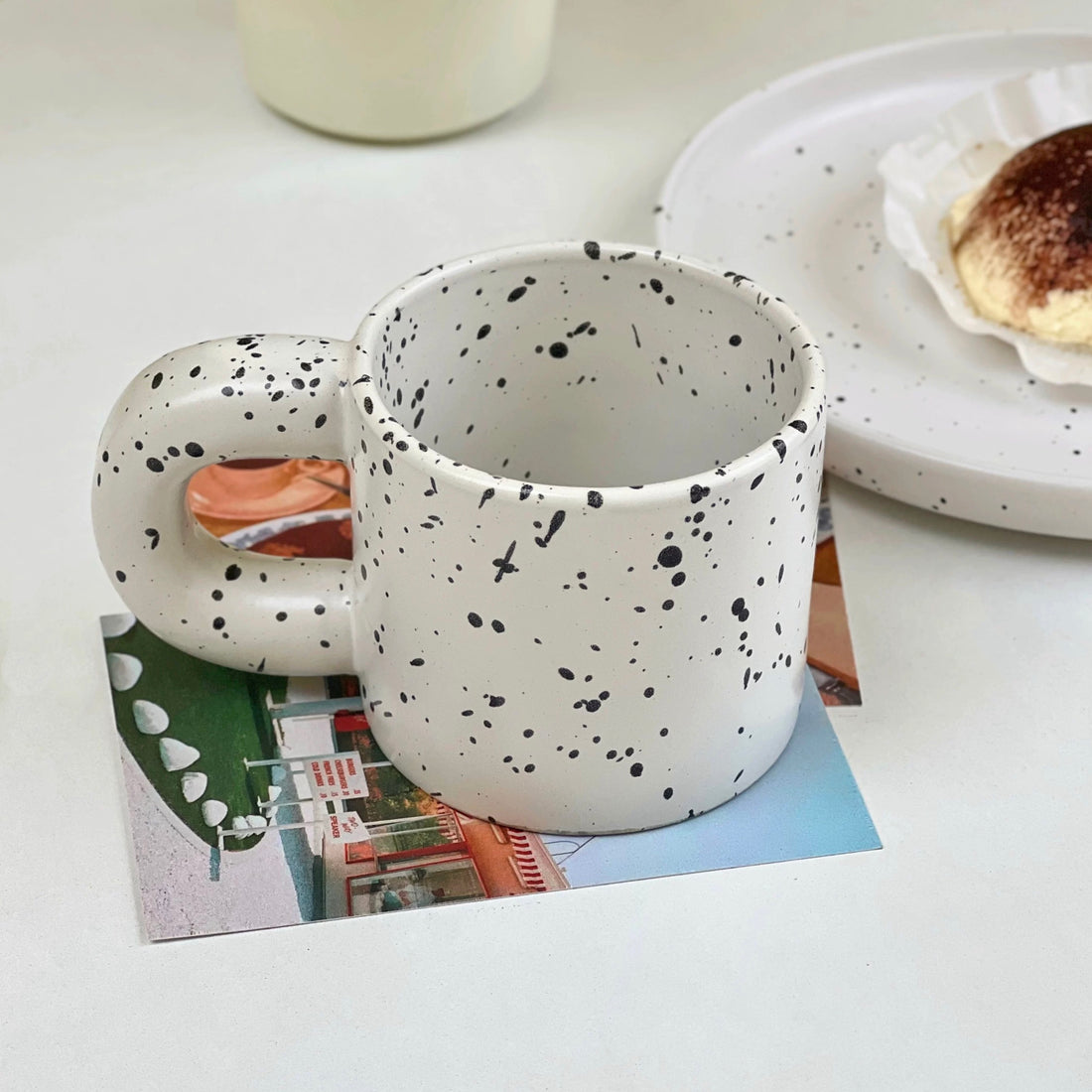 Handmade ceramic mug with black ink splatter