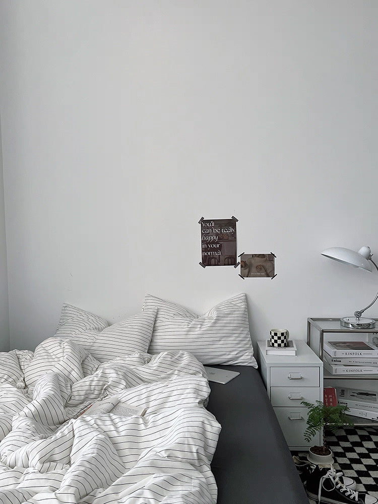 Bedroom with a bed, nightstand, and wall decorations.