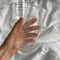 Clear glass tumbler with minimalist letter design